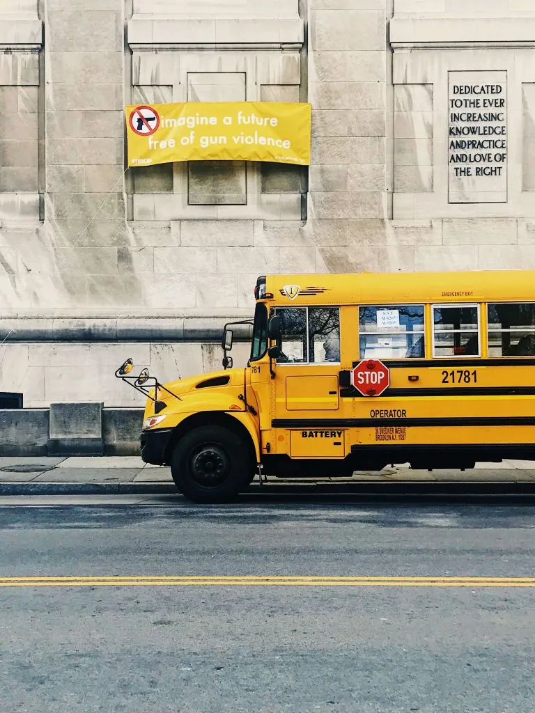 A school bus and the banner with no guns slogan